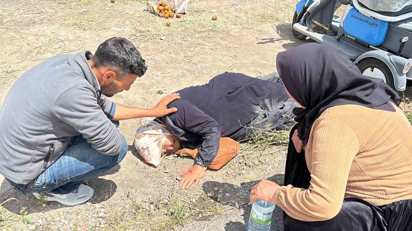 Yerde yatan yaralı kadına mont ile gölgelik yaptılar