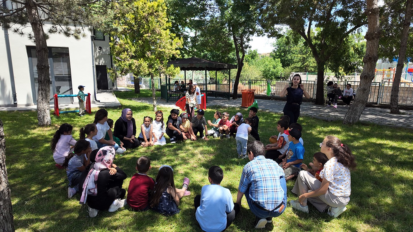 Kütüphane geziyor, çocuklar hem okuyor hem eğleniyor